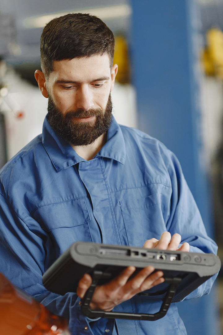 Car breakdown. Mechanic with a beard. Car on hoist.